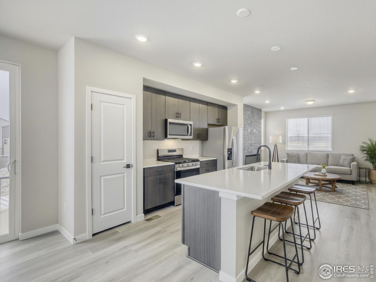 2367 East Suniga Road Fort Collins, CO 80524 - Photo 8 of 26 a large kitchen with kitchen island a stove a sink a refrigerator and a island