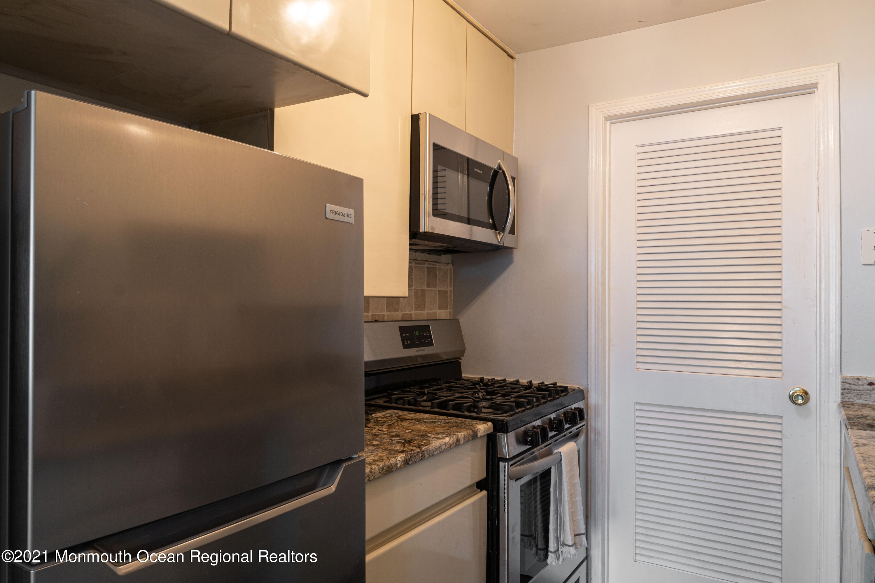 100 1st Street, Unit 5 Keyport, NJ 07735 - Photo 6 of 18 a kitchen with a stove and a microwave