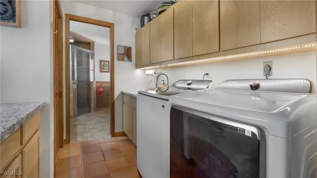 an aerial view of residential house with outdoor space and trees all around