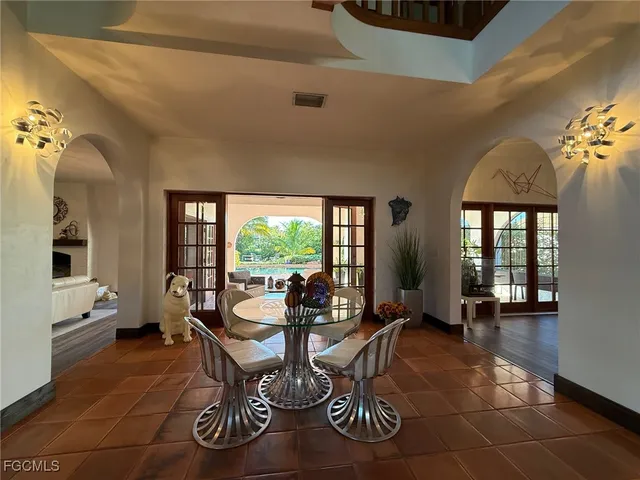a living room with furniture and floor to ceiling windows
