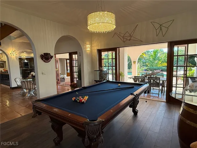 a room with pool table and windows