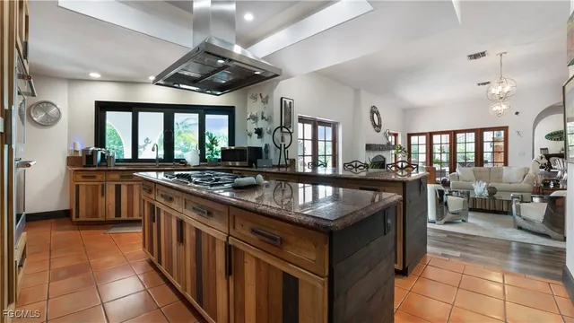 a kitchen with granite countertop a sink counter top space a stove and cabinets