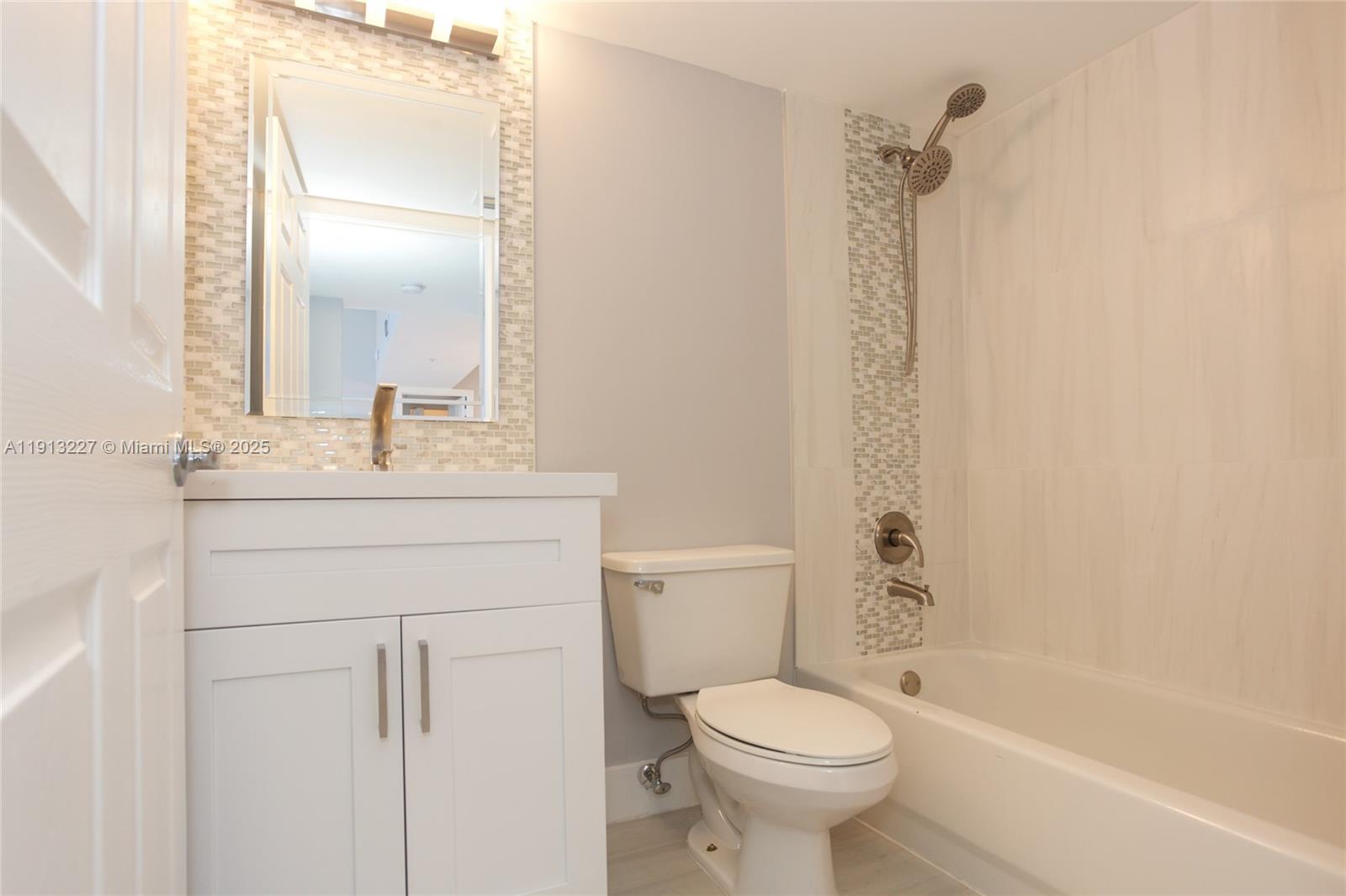 1350 Southeast 3rd Avenue, Unit 404 Dania Beach, FL 33004 - Photo 13 of 26 a bathroom with a sink toilet and shower