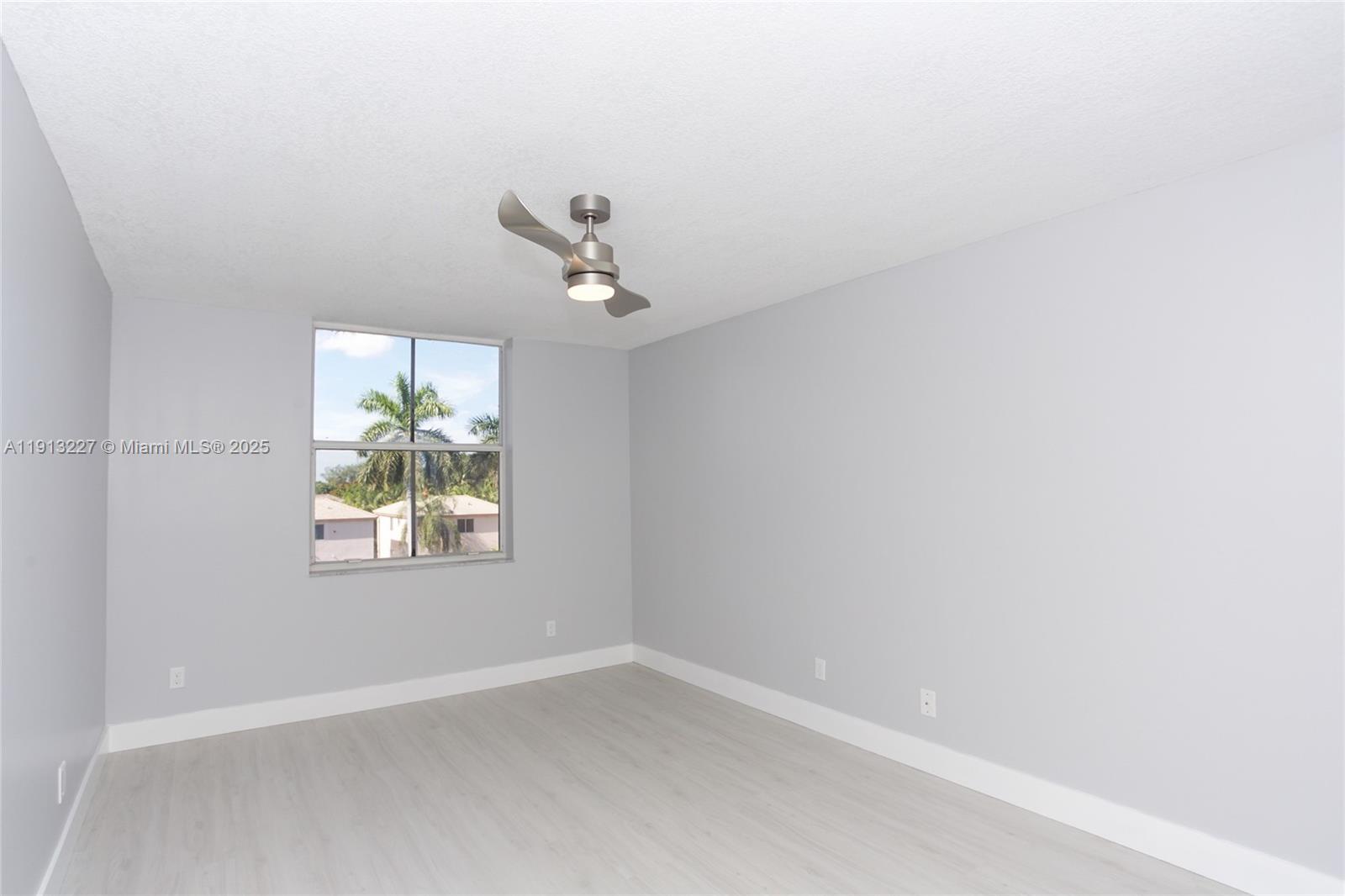 1350 Southeast 3rd Avenue, Unit 404 Dania Beach, FL 33004 - Photo 17 of 26 an empty room with a window
