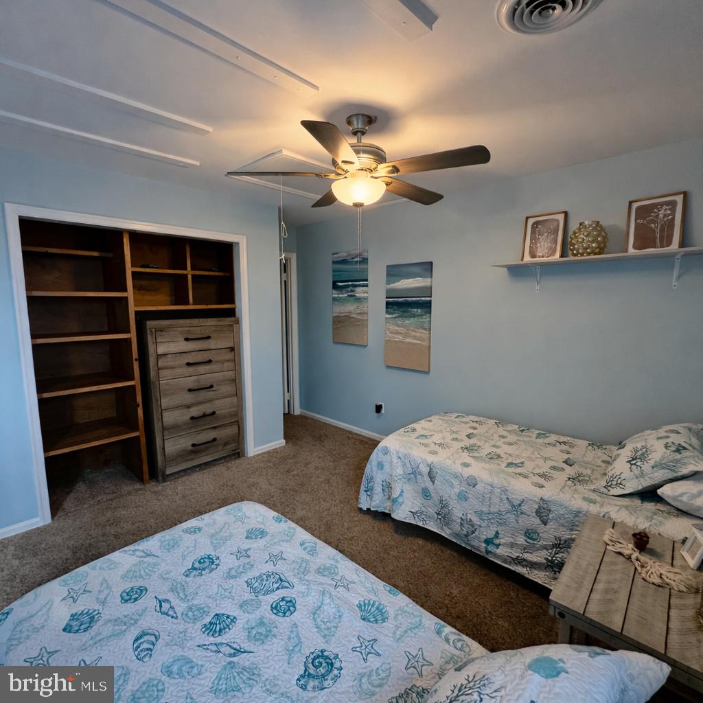 105 120th Street, Unit 37 Ocean City, MD 21842 - Photo 11 of 26 a bedroom with a bed and a dresser
