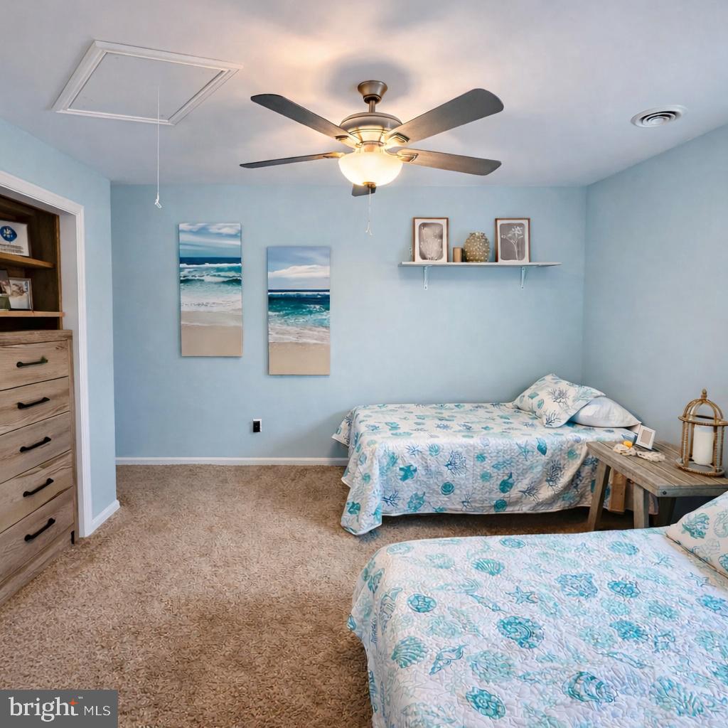105 120th Street, Unit 37 Ocean City, MD 21842 - Photo 12 of 26 a bedroom with a bed and a chandelier
