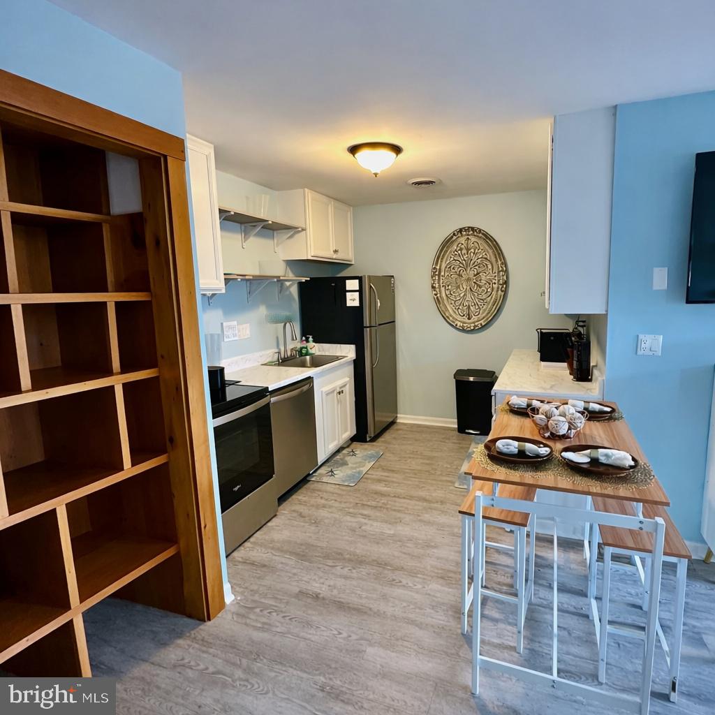 105 120th Street, Unit 37 Ocean City, MD 21842 - Photo 3 of 26 a kitchen with a stove and a cabinets