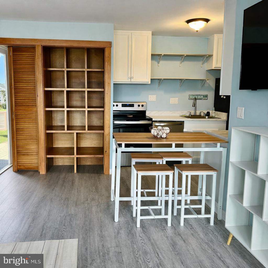105 120th Street, Unit 37 Ocean City, MD 21842 - Photo 6 of 26 a kitchen with granite countertop a stove top oven a sink and cabinets