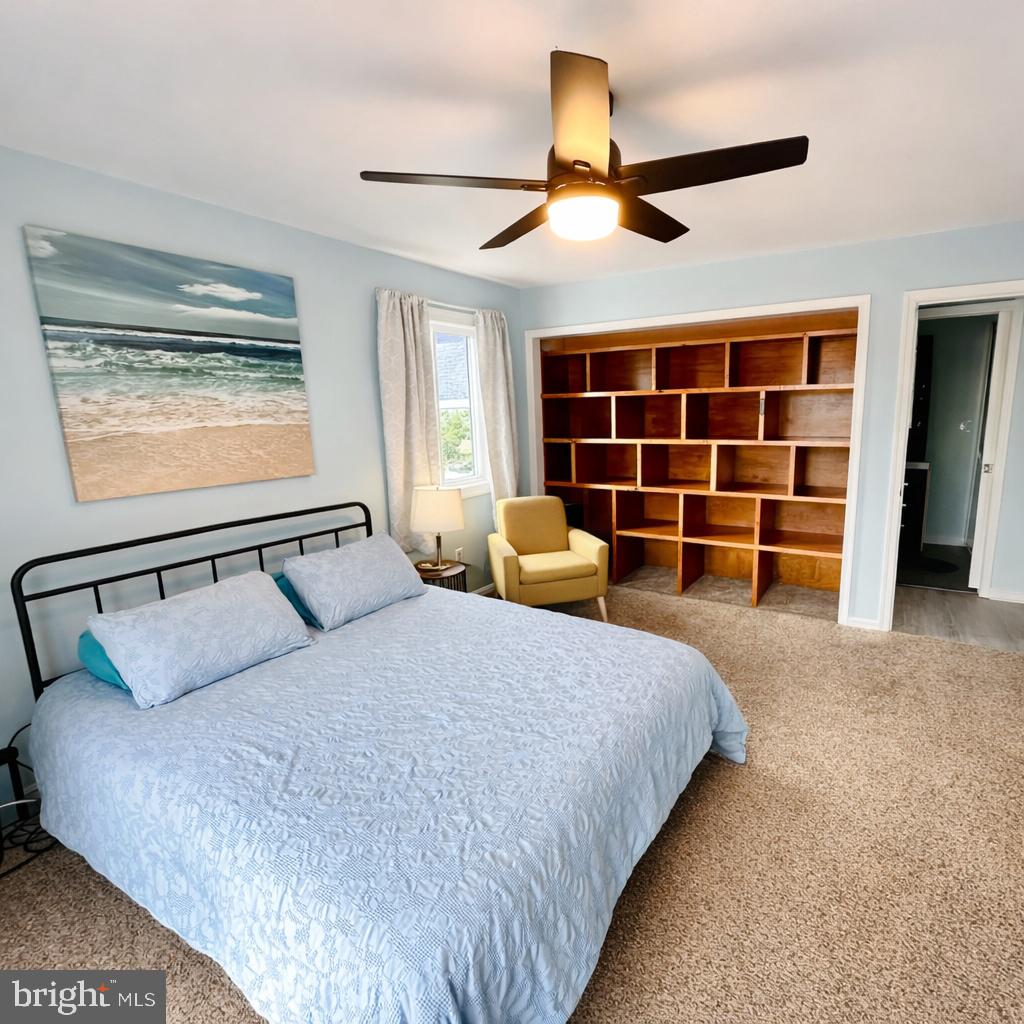 105 120th Street, Unit 37 Ocean City, MD 21842 - Photo 8 of 26 a bedroom with a large bed and ceiling fan