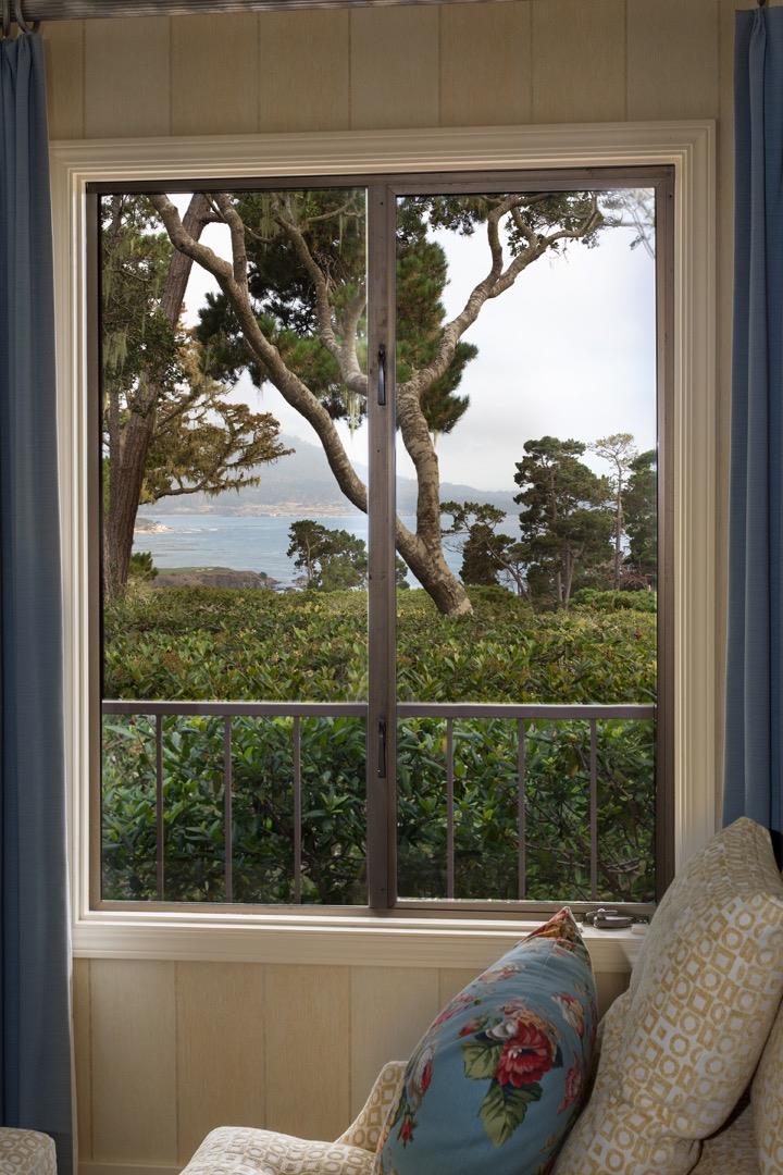 1477 Bonifacio Road Pebble Beach, CA 93953 - Photo 8 of 27 a view of a large window with a tree in front of it