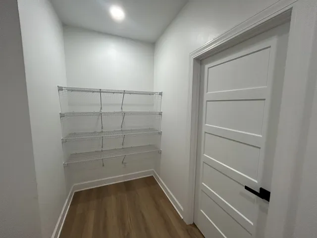 a view of walk in closet with empty racks