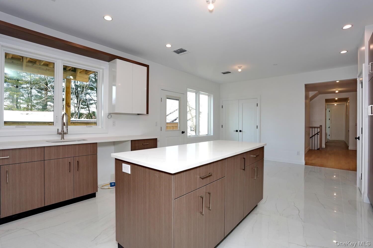4 Howard Drive, Unit 213 Spring Valley, NY 10977 - Photo 11 of 42 a kitchen with sink attached with living room