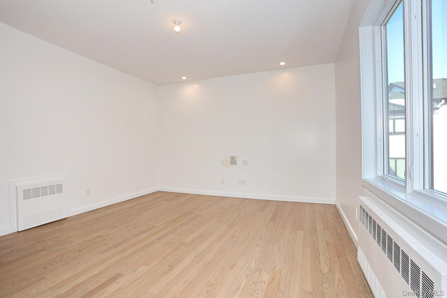4 Howard Drive, Unit 213 Spring Valley, NY 10977 - Photo 26 of 42 a view of empty room with wooden floor and fan