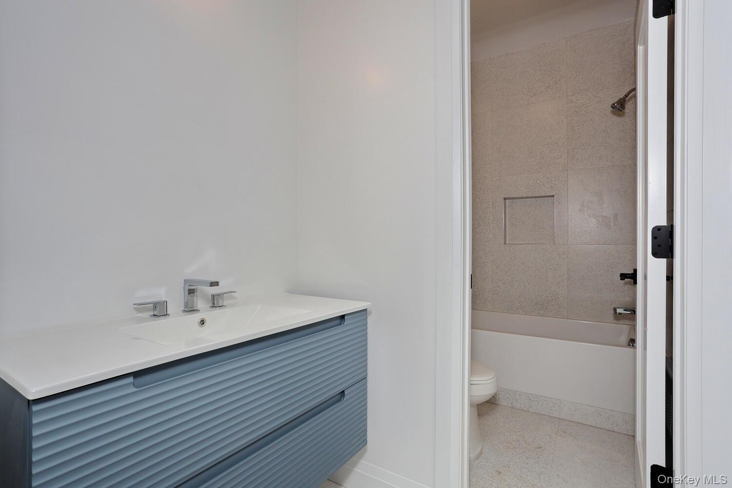 4 Howard Drive, Unit 213 Spring Valley, NY 10977 - Photo 32 of 42 a bathroom with a bathtub and a sink