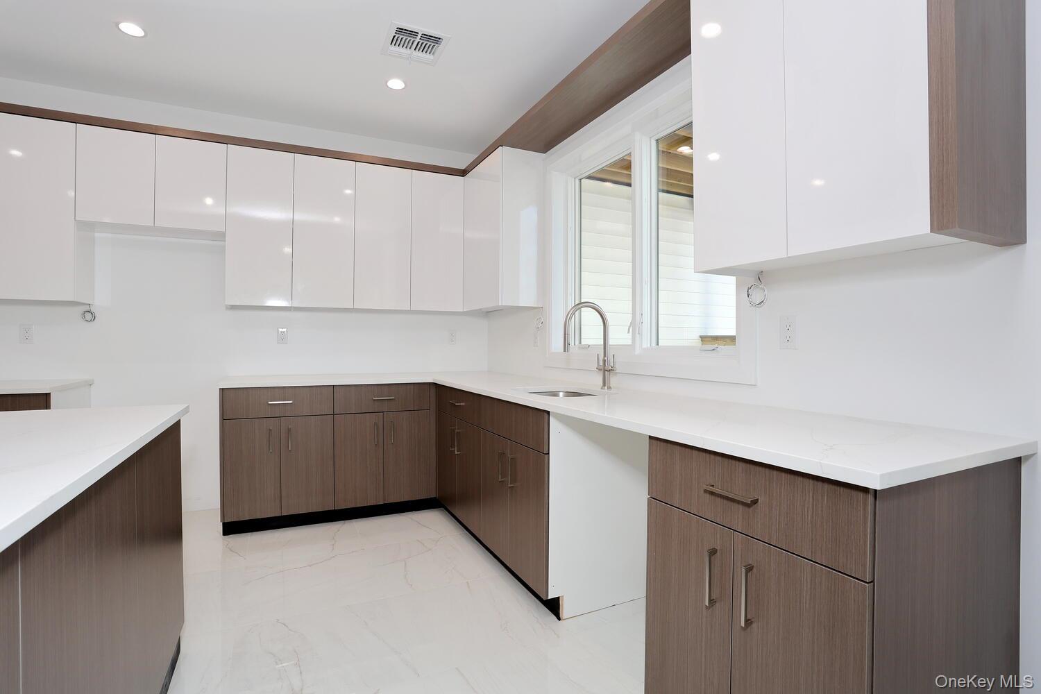 4 Howard Drive, Unit 213 Spring Valley, NY 10977 - Photo 7 of 42 a kitchen with a sink cabinets and window