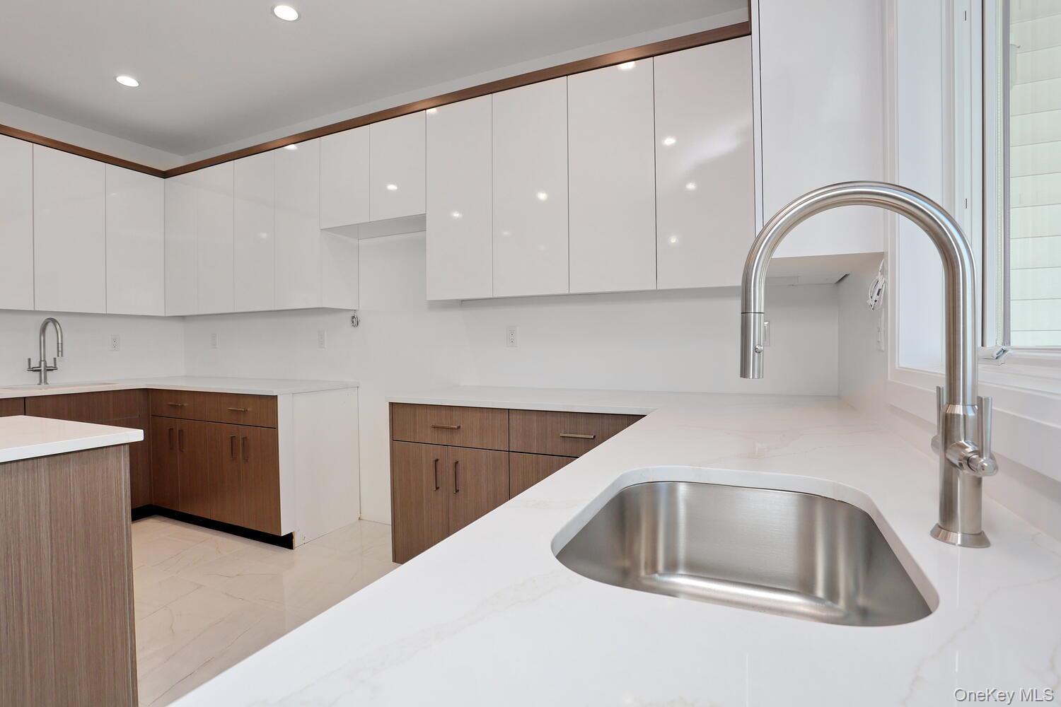 4 Howard Drive, Unit 213 Spring Valley, NY 10977 - Photo 8 of 42 a kitchen with sink a refrigerator and cabinets
