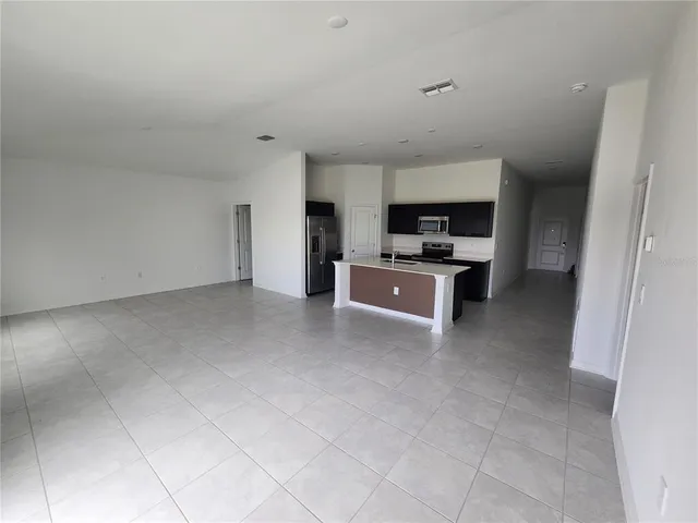 a view of a kitchen with a sink and a refrigerator