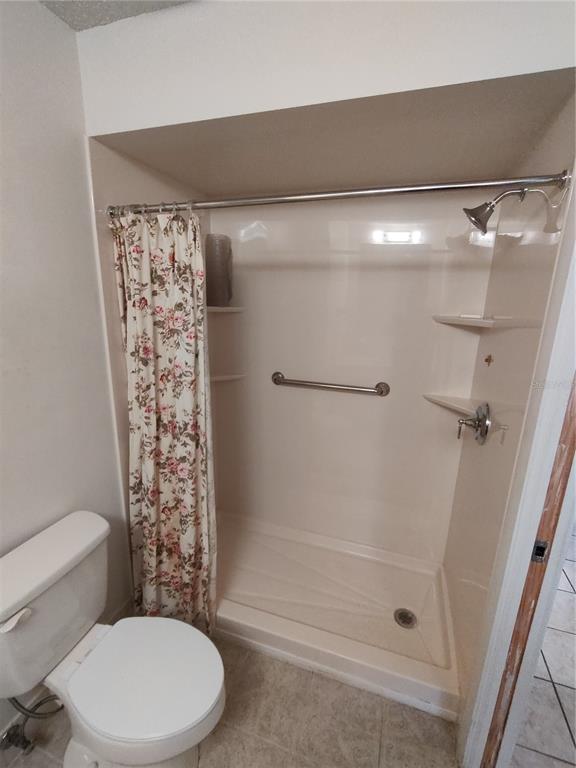 8565 Southwest 109th Street Ocala, FL 34481 - Photo 14 of 27 a bathroom with a toilet and shower