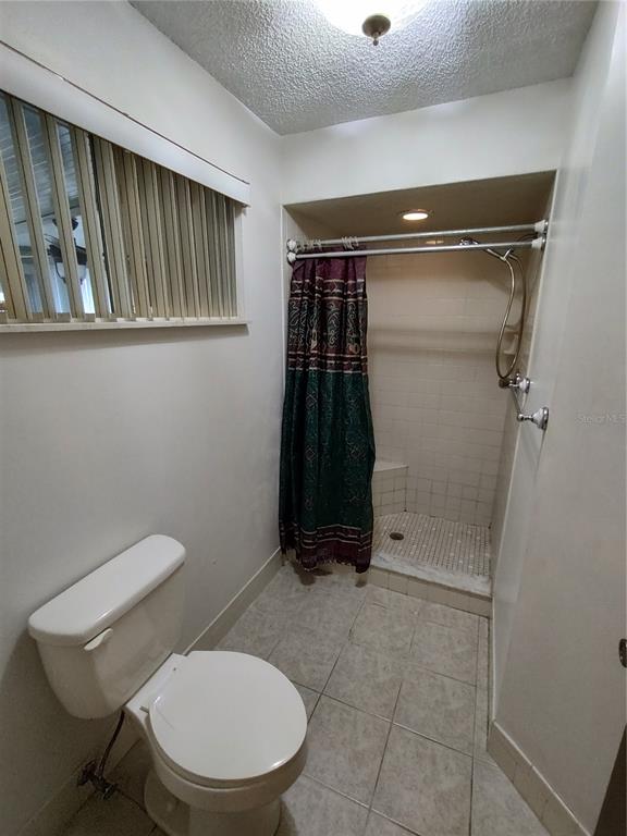 8565 Southwest 109th Street Ocala, FL 34481 - Photo 18 of 27 a bathroom with a toilet and a shower