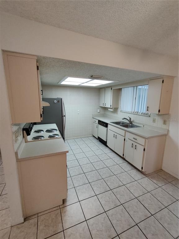 8565 Southwest 109th Street Ocala, FL 34481 - Photo 10 of 27 a kitchen with stainless steel appliances granite countertop a stove a sink and a refrigerator