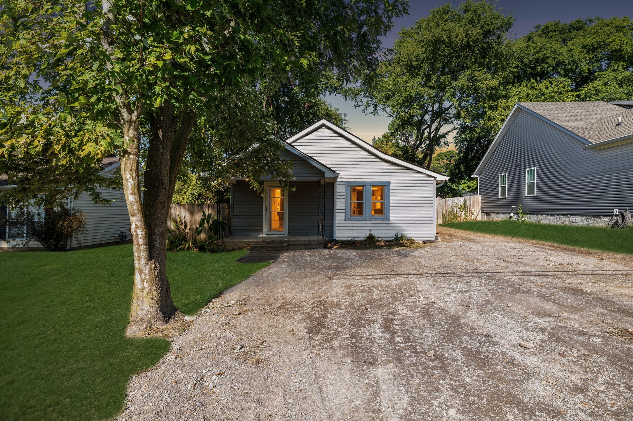 a view of a house with yard and a tree