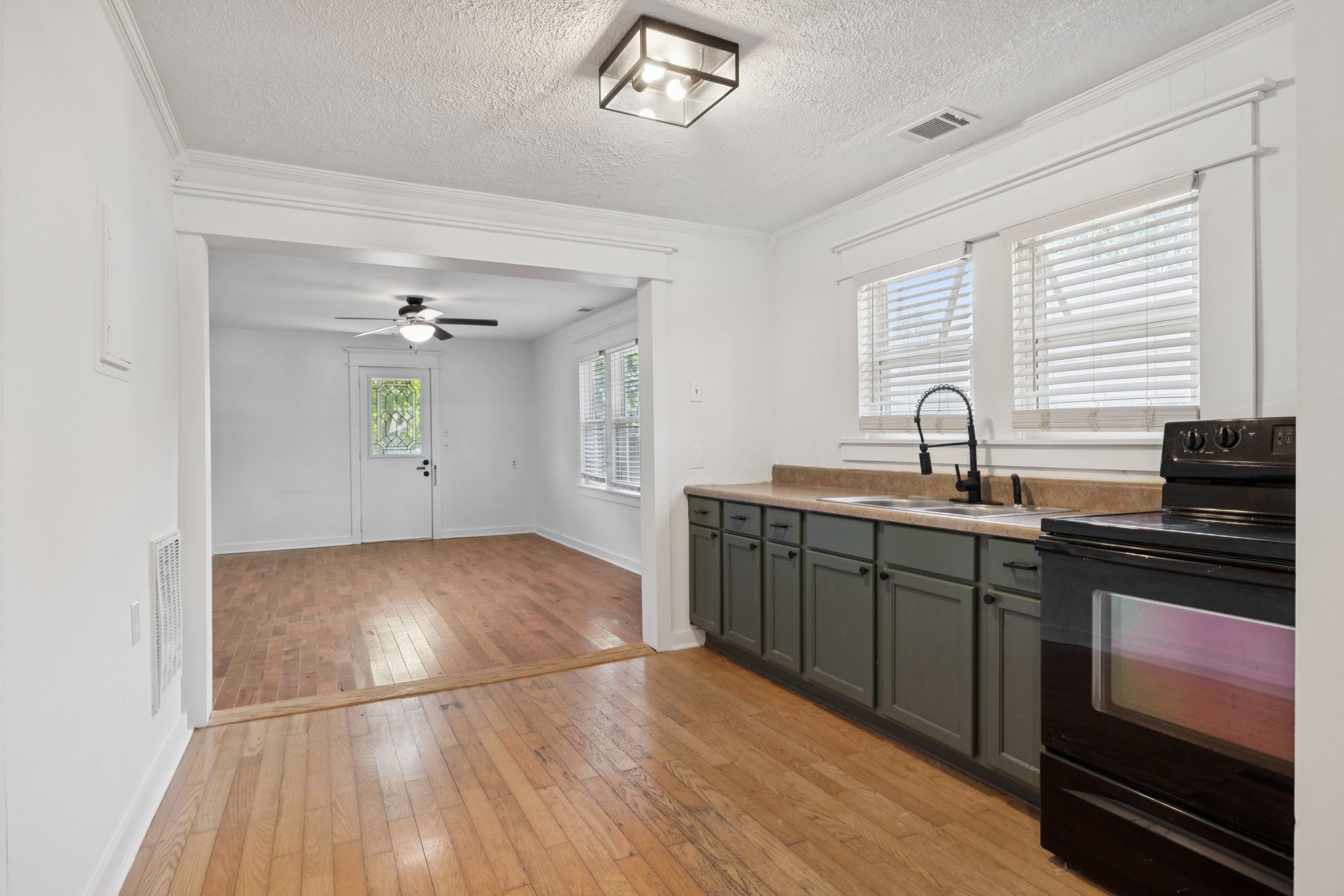1008 Bales Street Gallatin, TN 37066 - Photo 5 of 19 a kitchen with granite countertop a stove a sink and a refrigerator