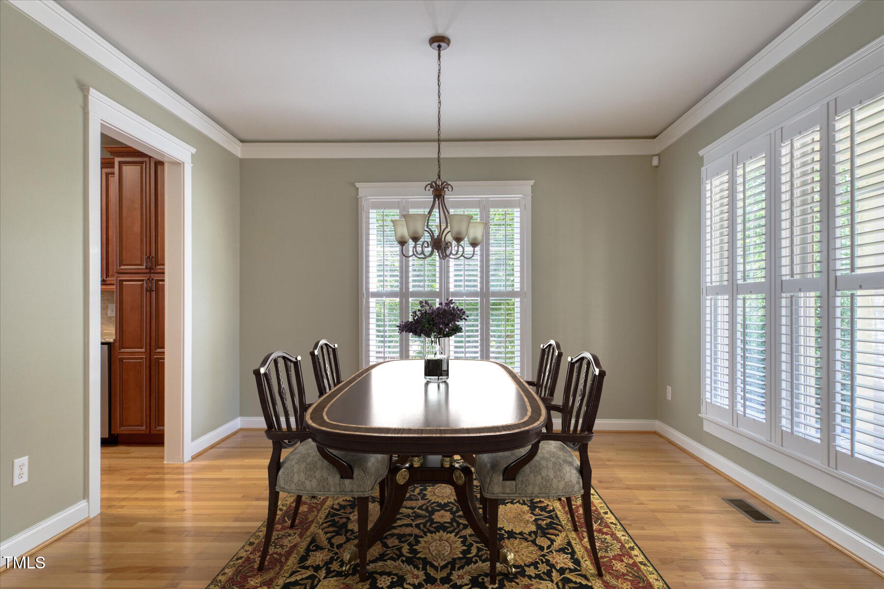 121 Bridgegate Drive Cary, NC 27519 - Photo 6 of 38 a dining room with furniture a chandelier and wooden floor