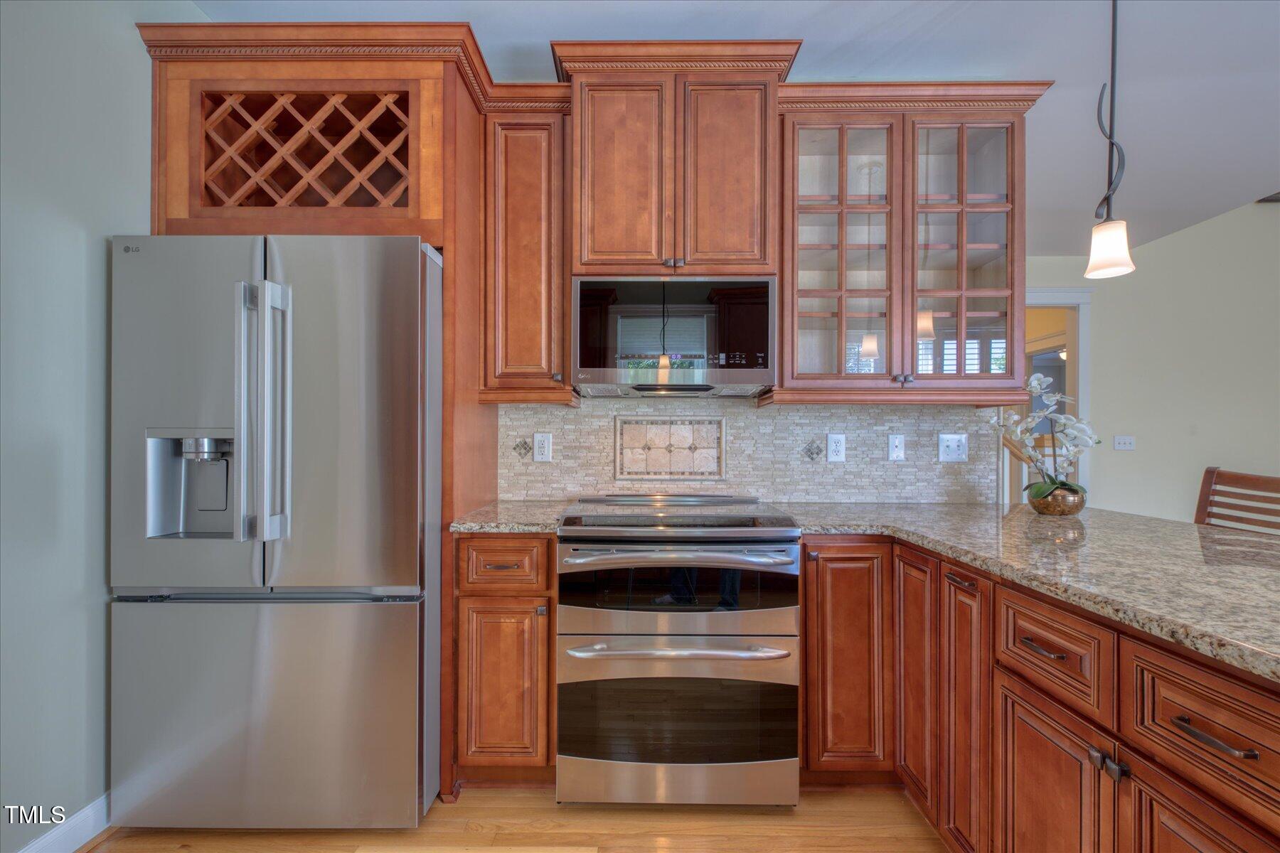 121 Bridgegate Drive Cary, NC 27519 - Photo 7 of 38 a kitchen with stainless steel appliances granite countertop a refrigerator and a sink