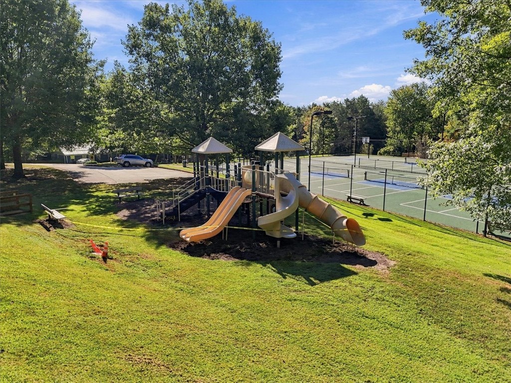 211 Cedar Ridge Drive Westminster, SC 29693 - Photo 32 of 34 A spacious recreation area features a modern playground structure alongside well-maintained tennis courts.