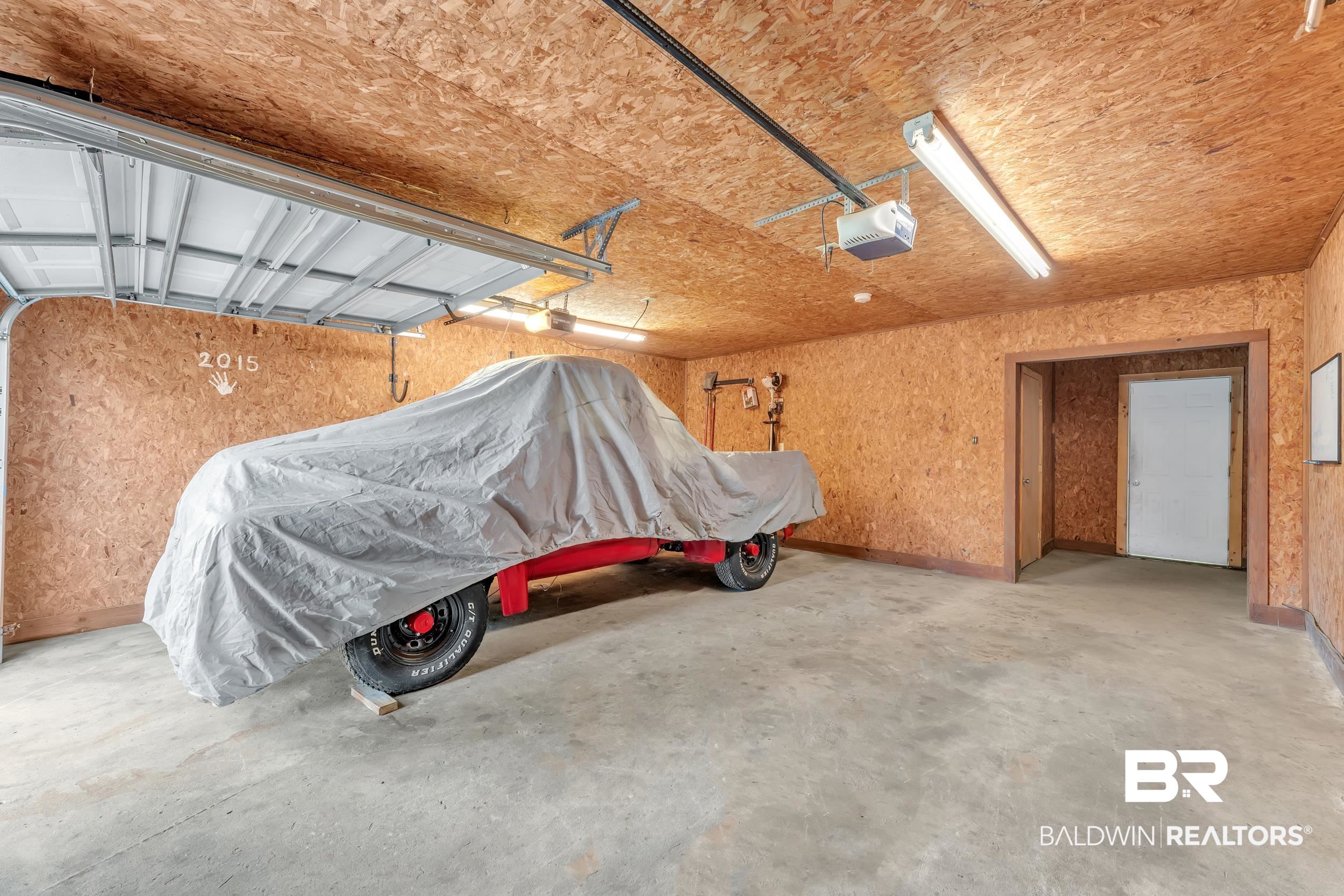 206 West Jackson Avenue Summerdale, AL 36580 - Photo 28 of 37 Garage featuring a garage door opener