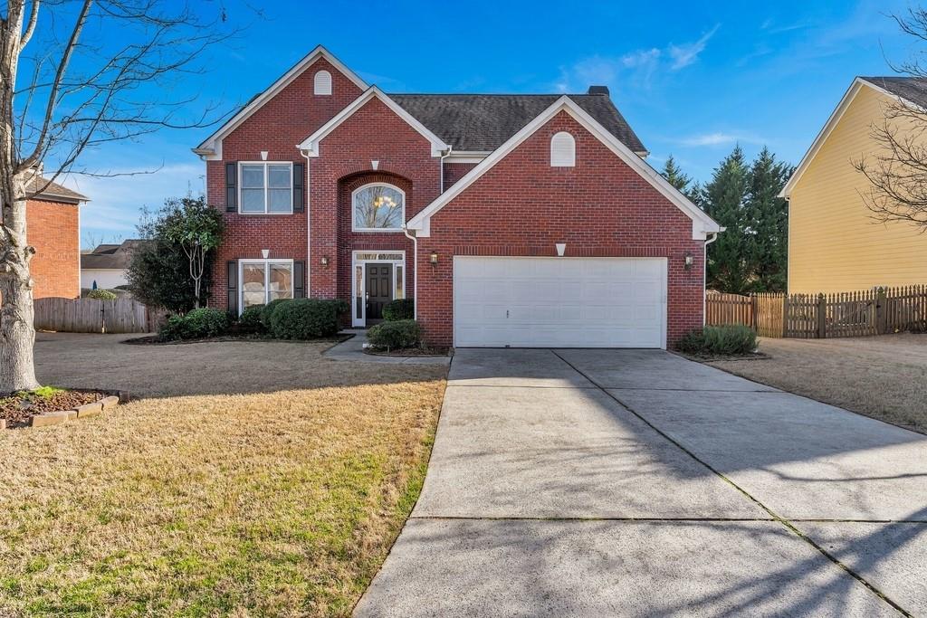 115 Treadstone Overlook Suwanee, GA 30024 - Photo 1 of 1 a front view of a house with a yard