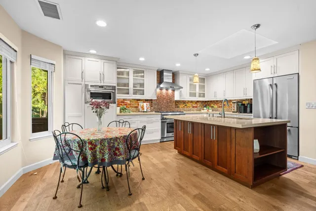 a kitchen with stainless steel appliances granite countertop a sink and stove