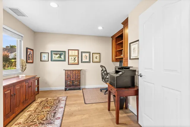 a living room with furniture a rug and a fireplace
