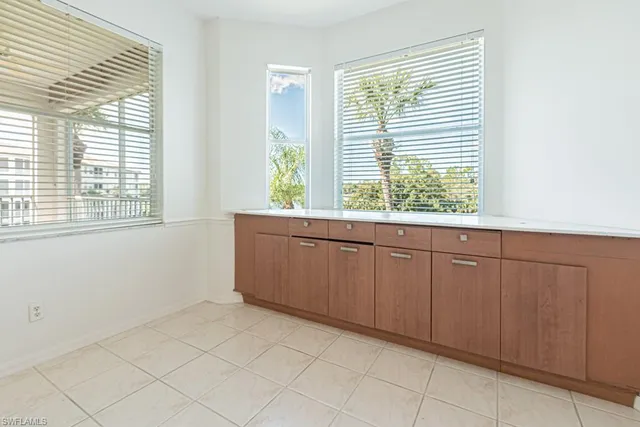 a view of a kitchen with white cabinets and a stove top oven