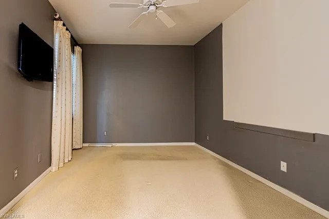 a view of a livingroom with wooden floor and a flat screen tv