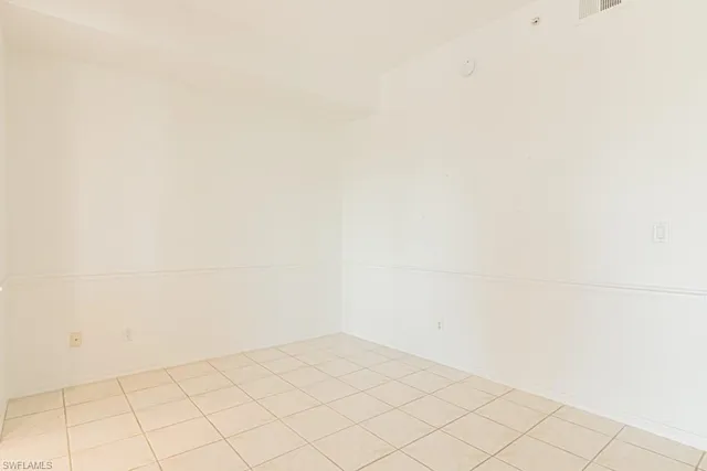 a living room with a large mirror and furniture