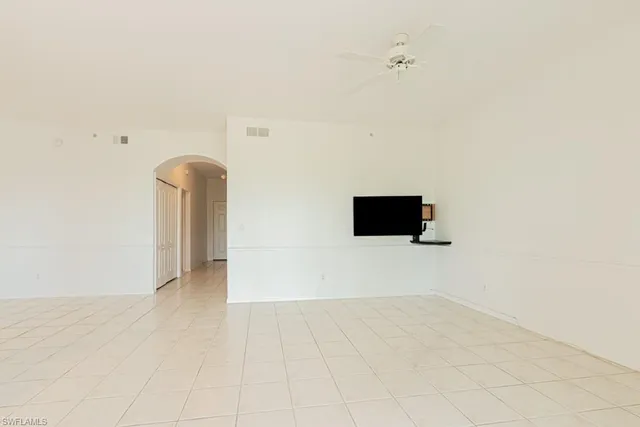 a view of an empty room with a kitchen