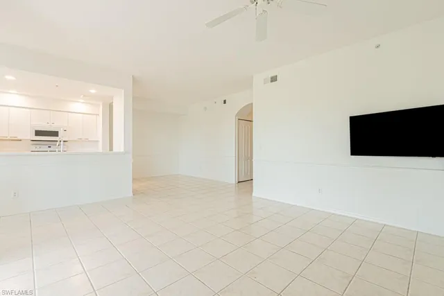 a view of a kitchen with an empty space and a window