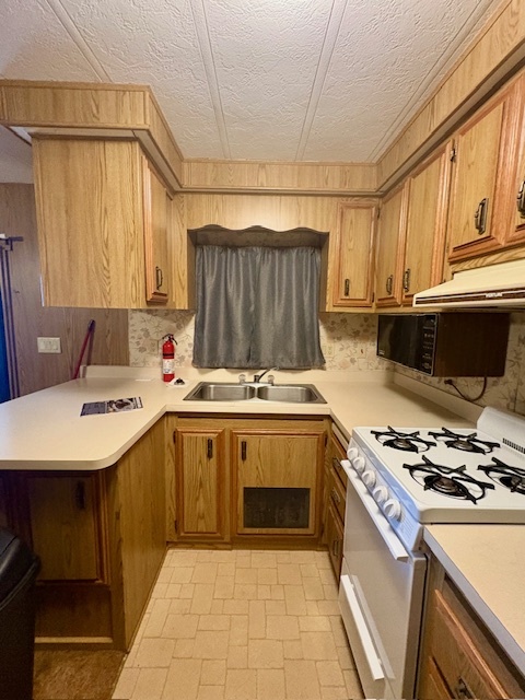 11-85 Woodhaven Sublette, IL 61367 - Photo 14 of 26 a kitchen with a stove a sink and a refrigerator