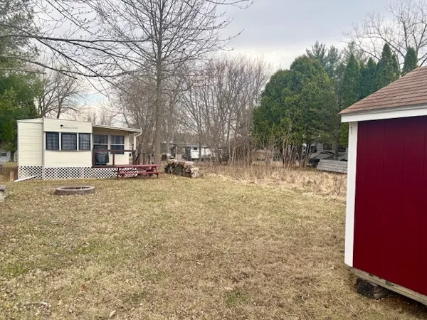 a view of a house with a yard covered in snow