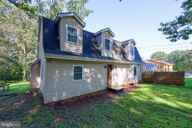 a front view of a house with a garden and yard