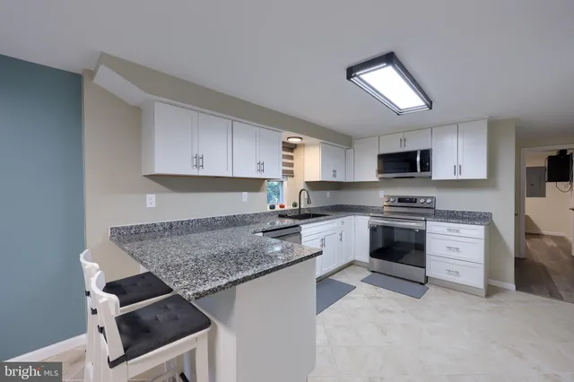 a kitchen with granite countertop cabinets
