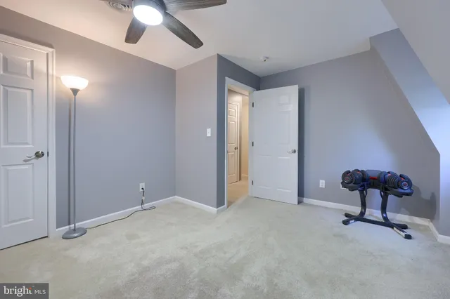 a spacious bathroom with a toilet sink and mirror
