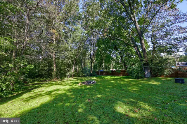 a backyard of a house with lots of green space and deers