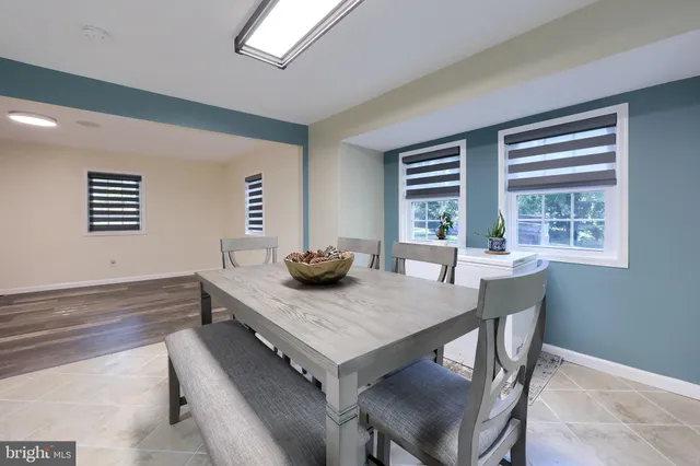 a kitchen with a dining table chairs and microwave