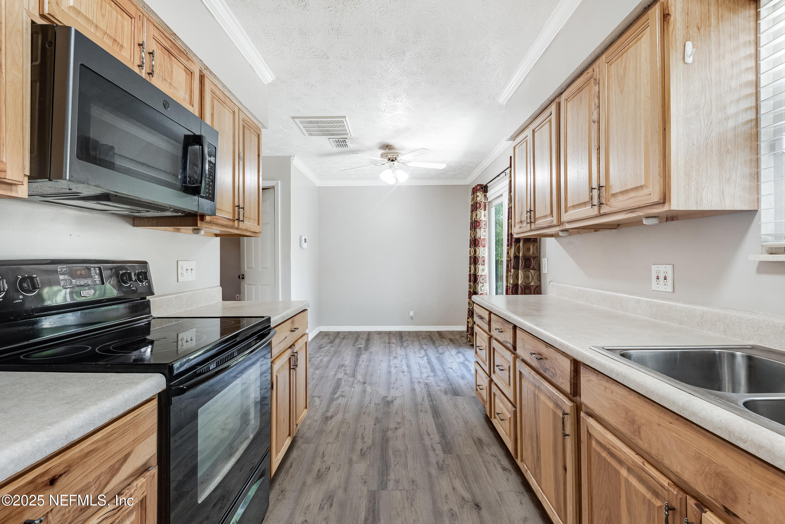 6149 Post Oak Road West Jacksonville, FL 32277 - Photo 11 of 25 a kitchen with a sink stove and microwave