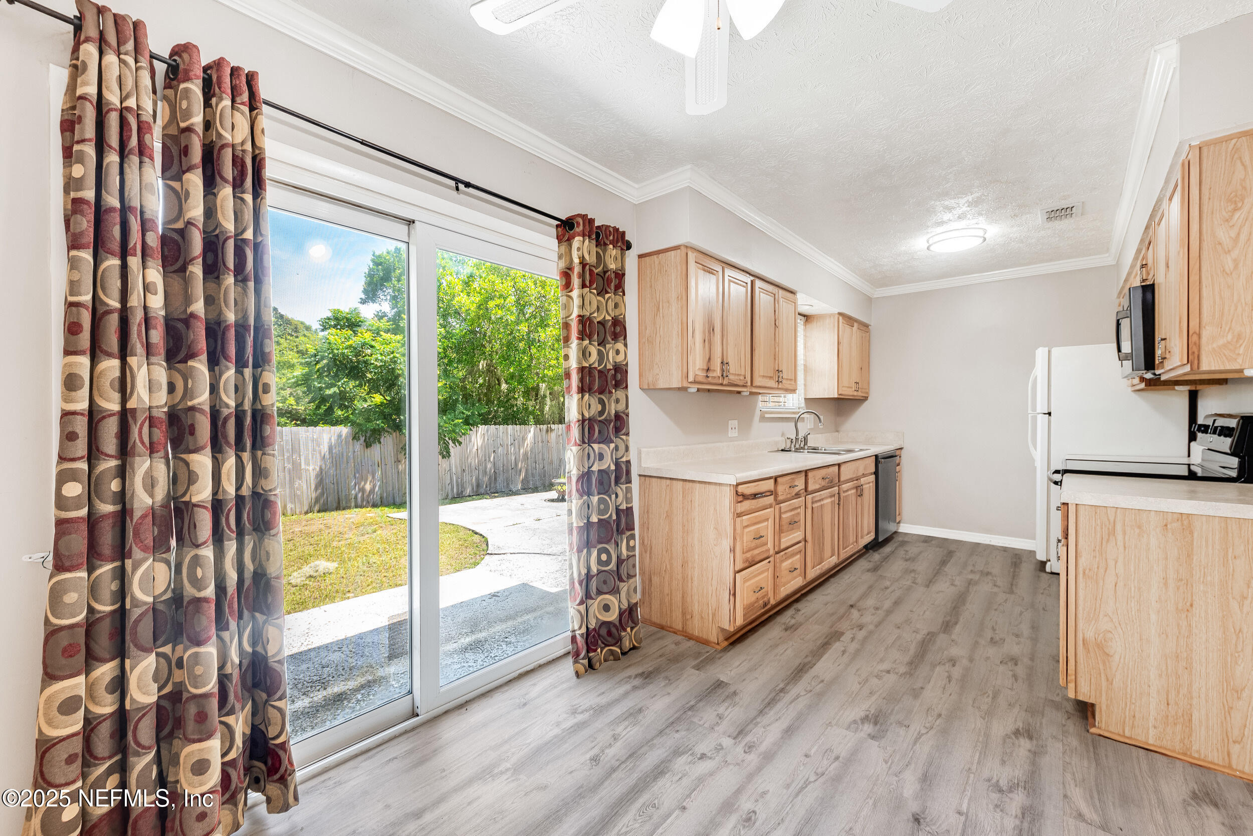 6149 Post Oak Road West Jacksonville, FL 32277 - Photo 12 of 25 a kitchen with stainless steel appliances granite countertop a stove a sink and a refrigerator