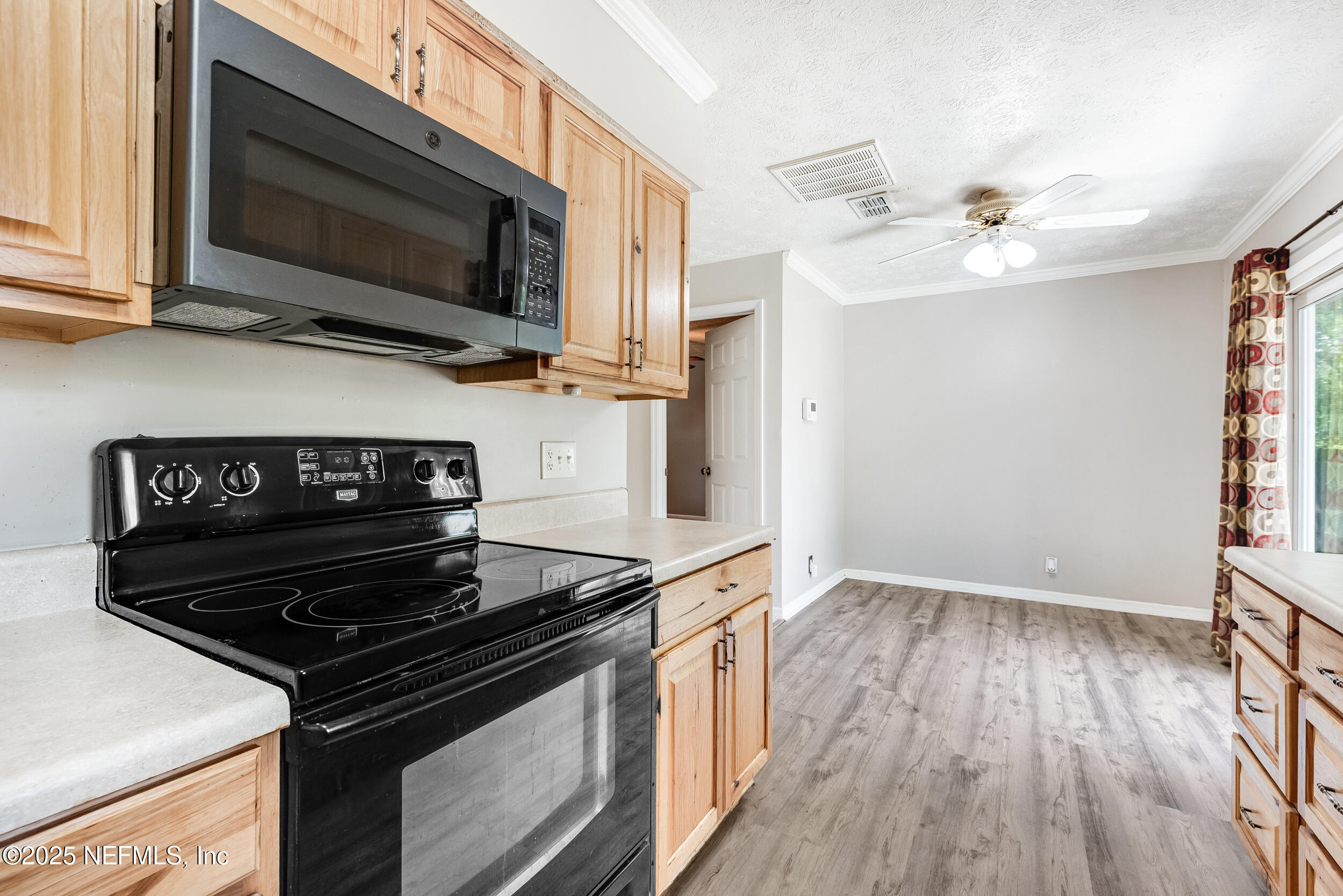 6149 Post Oak Road West Jacksonville, FL 32277 - Photo 13 of 25 a kitchen with a stove and a microwave