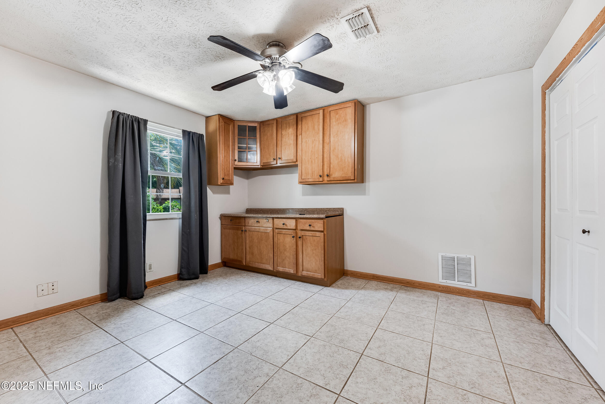 6149 Post Oak Road West Jacksonville, FL 32277 - Photo 21 of 25 a kitchen with stainless steel appliances granite countertop a refrigerator a sink a stove and white cabinets