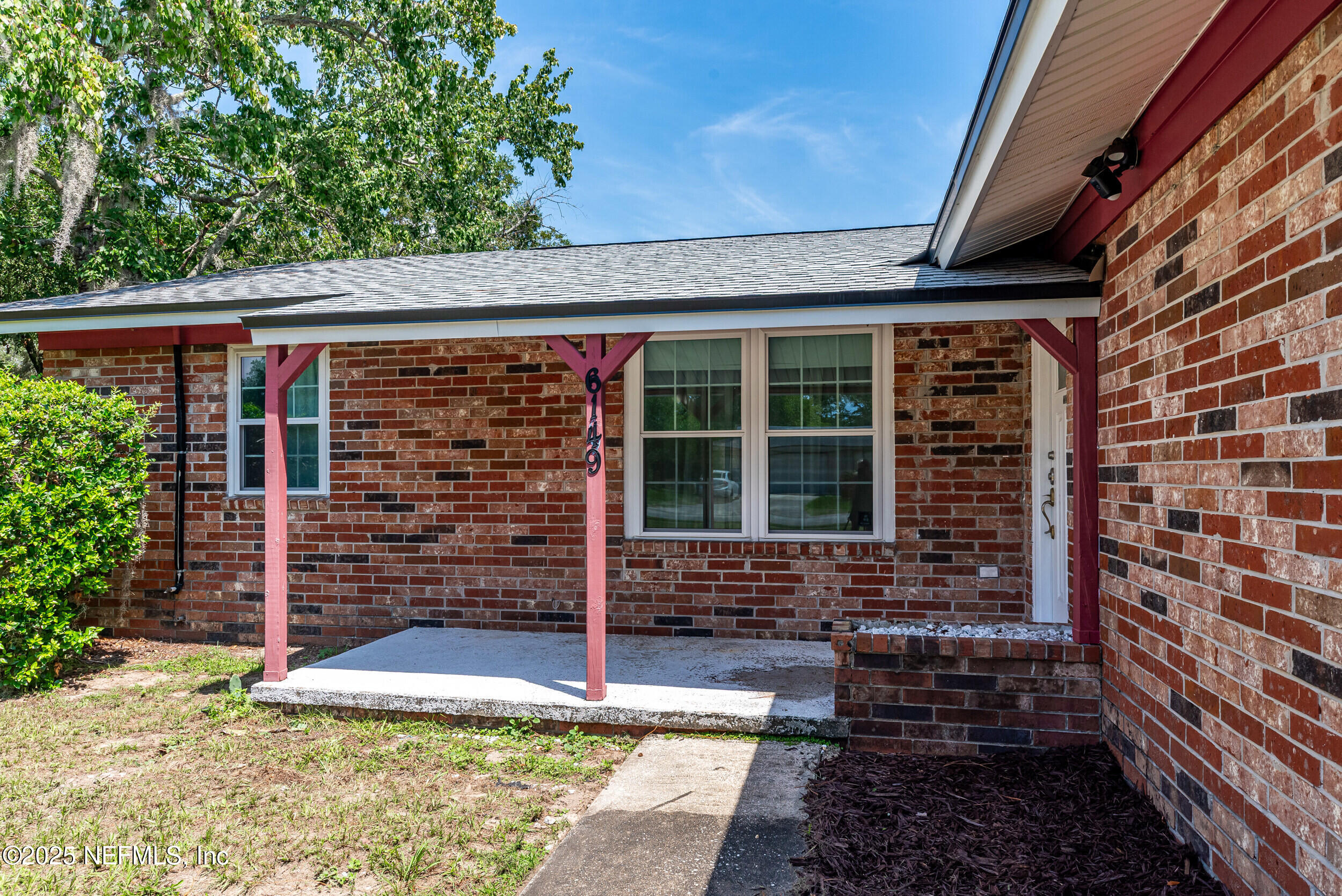 6149 Post Oak Road West Jacksonville, FL 32277 - Photo 4 of 25 a front view of a house with a garage